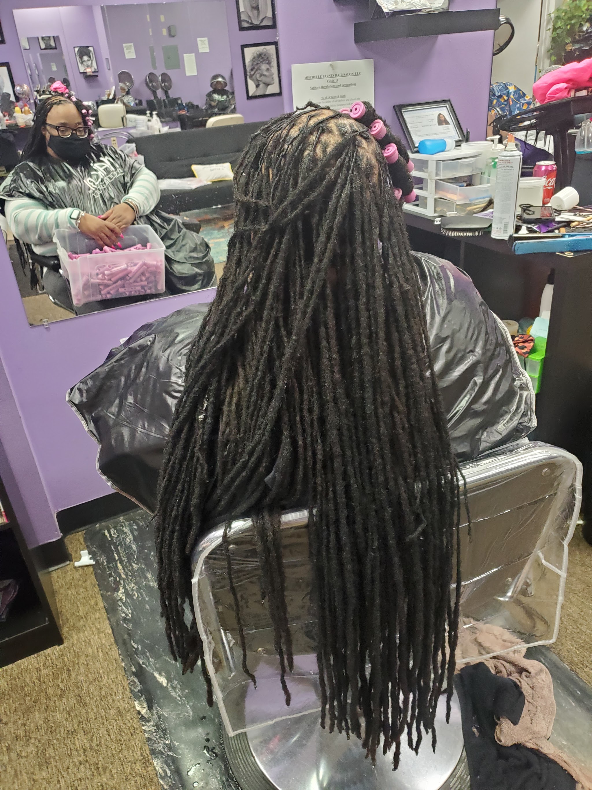Long locs on a client in the salon chair